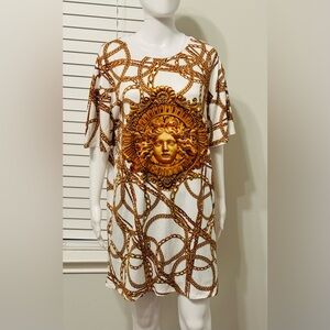 A dress with a Medusa head print and gold chains. This loose-fitting T-shirt